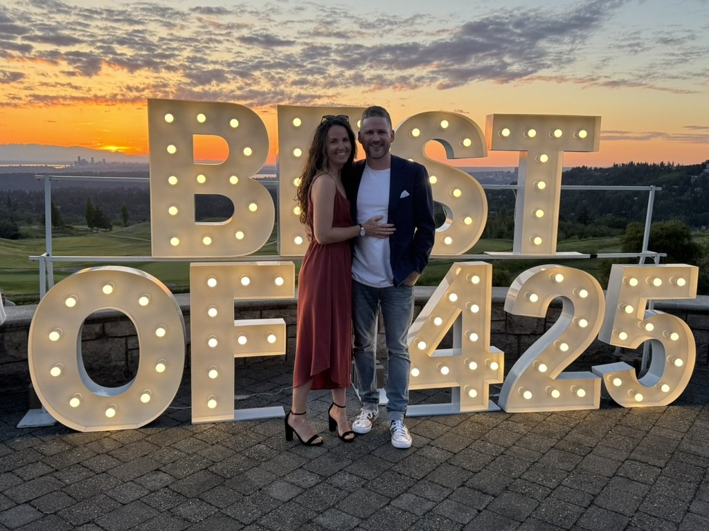 Keenan at the Best of 425 celebration at sunset, standing among lit marquee letters