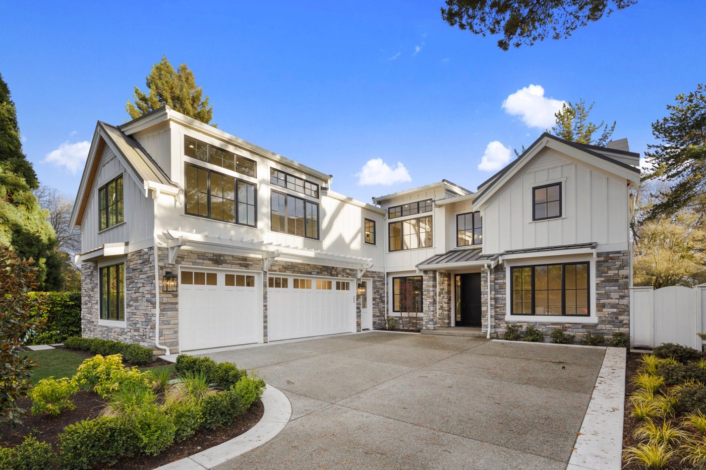 Modern farmhouse exterior with stone and board-and-batten siding, photographed by West Sound Photography