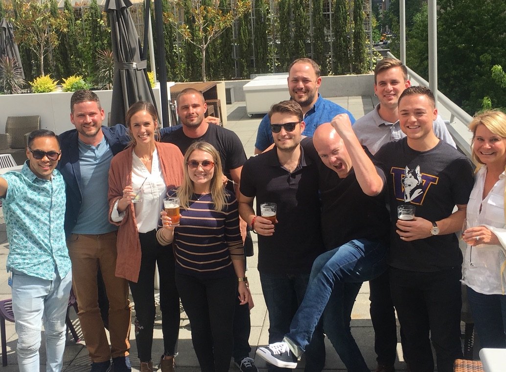 Keenan with the Zillow sales team on a sunny Seattle rooftop